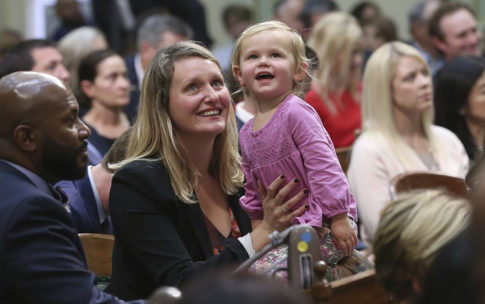 Assemblymember Buffy Wicks holds her daughter in the California Assembly Gallery during the legislative session